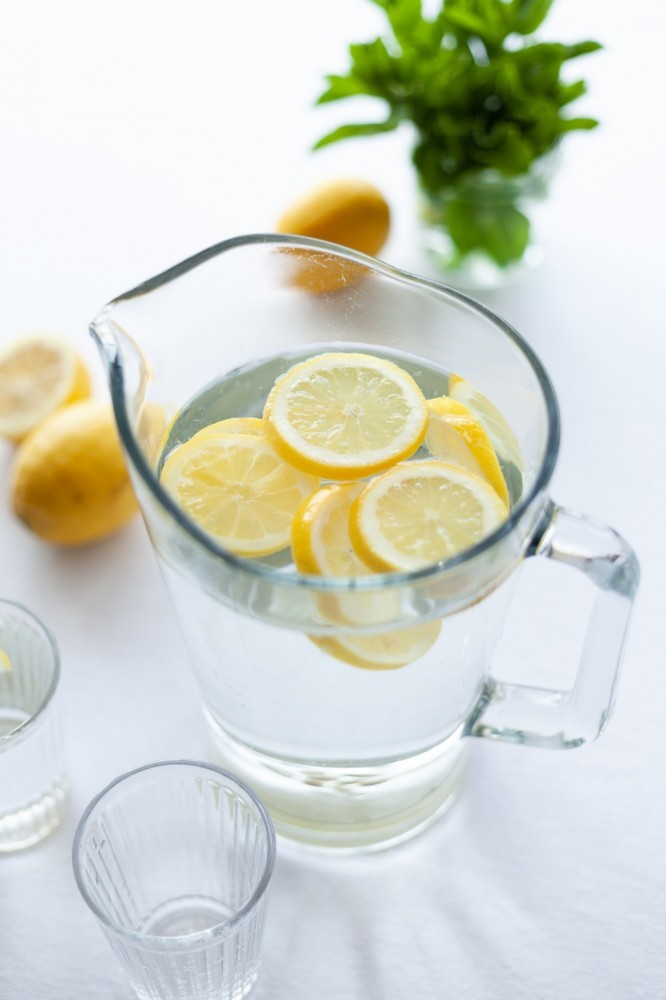 lemons in carafe of water showing lemons and weight loss effect